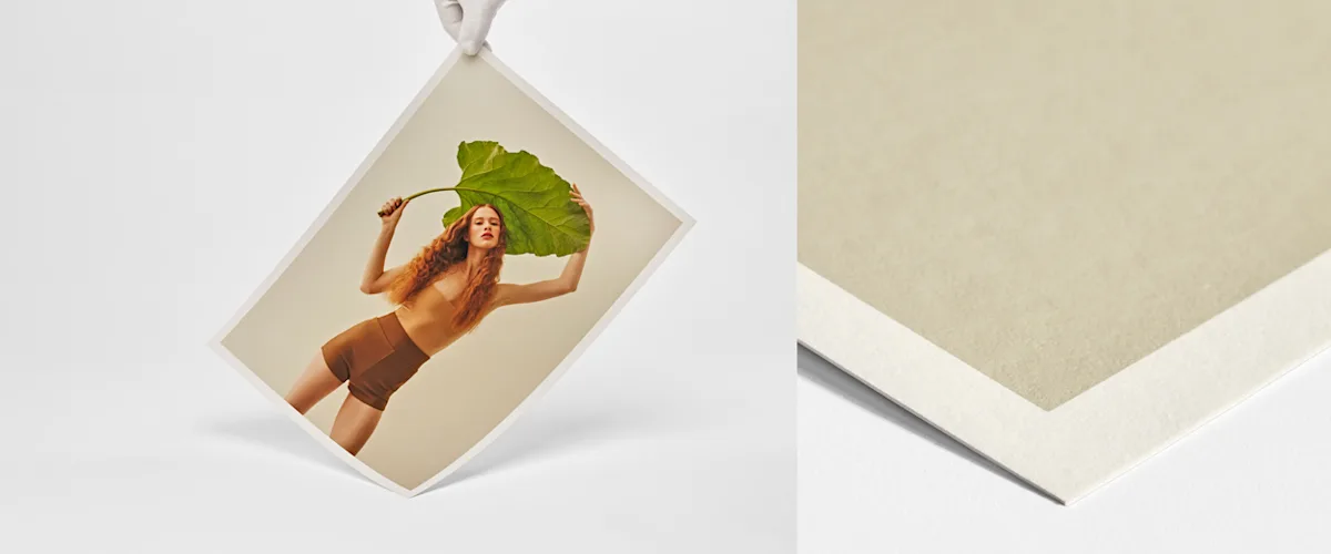 Fine Art Paper Hahnemühle Bamboo Hand with white gloves holding fine art print with portrait of a woman with a plant on matte paper.