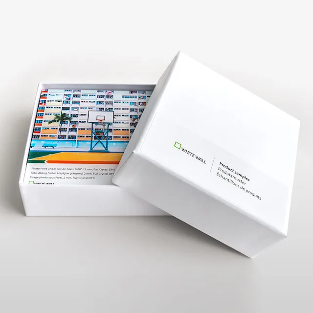 Shopify | Product Grid Section | Produktmuster Kachel White box with open lid shows colorful printed product samples from WhiteWall.