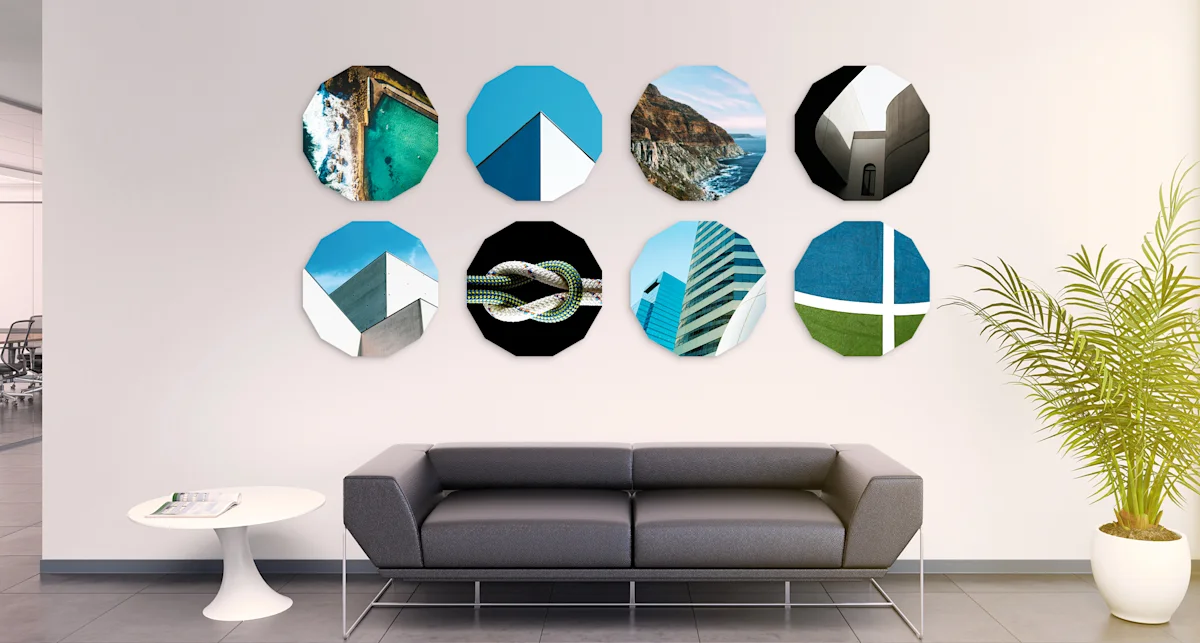 PDP | Round Format & Shapes | Big Picture Slider Section > Jewel | Slide #1 | Media #1 8 different motifs in the shape of a dodecagon hang side by side in two rows on a wall in an office building.