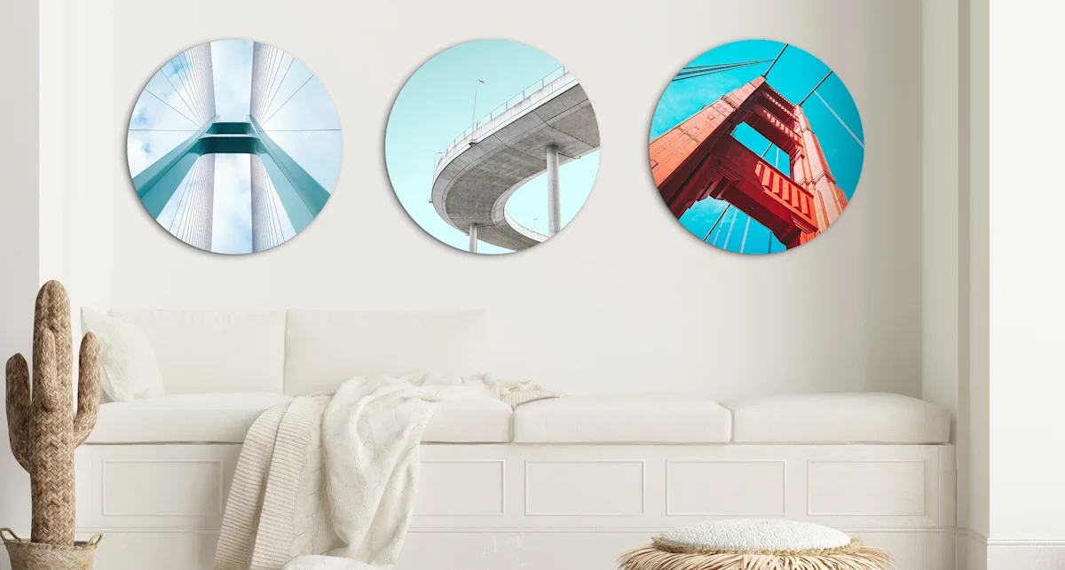 PDP | Round Format & Shapes | Big Picture Slider Section > Round Photo > Slide #4 | Media #1 3 different round pictures with street bridges are hung next to each other on a wall.