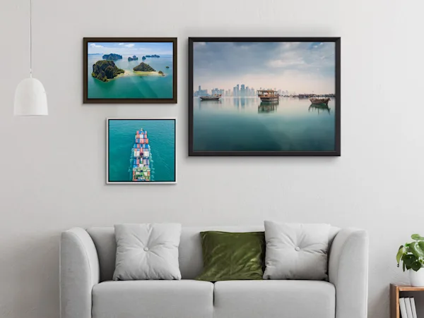 Photo Print On Aluminum Backing Several different motifs on a Photo Print On Aluminum Backing with different frames hang on a wall in a living room.