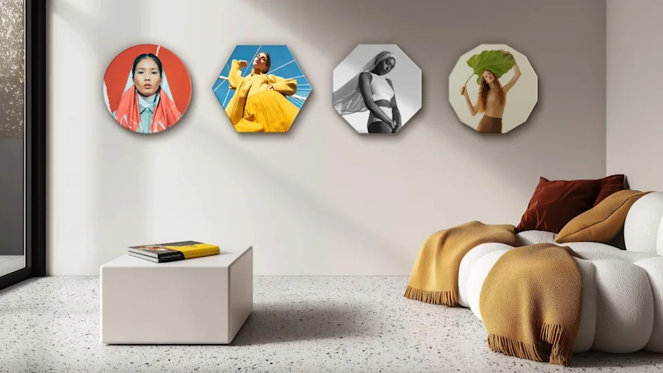 4 differently shaped wall prints hanging on a wall.